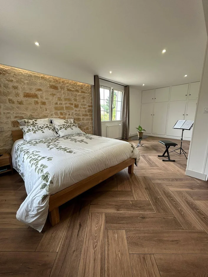 Warm Modern Bedroom Renovation with Natural Stone Accent